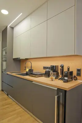 a kitchen with white cabinets and a counter top at Stylish Ilisia Stay Luxury Fully Reno 2BR, 2BA Apt in Athens