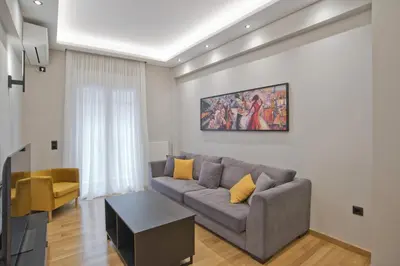 a living room with a couch and a table at Stylish Ilisia Stay Luxury Fully Reno 2BR, 2BA Apt in Athens