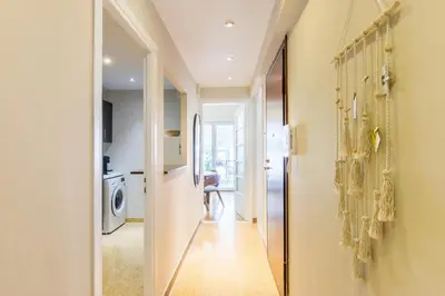 a hallway with a door leading to a room with a kitchen at Modern Home W Balcony Near Kolonaki in Athens