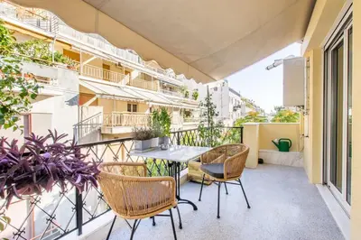 a balcony with chairs and a table on a building at Modern Home W Balcony Near Kolonaki in Athens