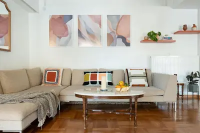 a living room with a couch and a table at Almost A Penthouse But Better W Acropolis Glimpse in Athens