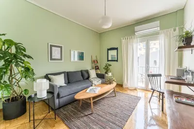 a living room with a couch and a table at Quiet 1br Home Near Plaka & Acropolis in Athens