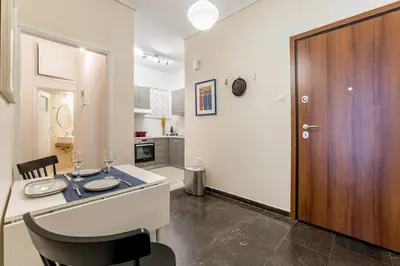 a kitchen and dining room with a table and chairs at Quiet 1br Home Near Plaka & Acropolis in Athens
