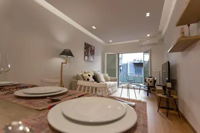 a living room with two white plates on a table at Cozy apartment in Koukaki in Athens