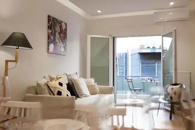 a living room with a couch and a table at Cozy apartment in Koukaki in Athens