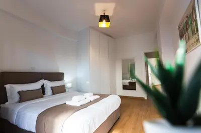 a bedroom with a bed with two towels on it at Cozy apartment in Koukaki in Athens