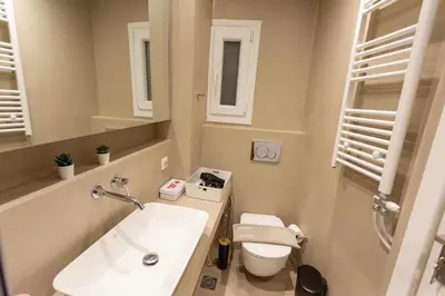 a small bathroom with a sink and a toilet at Cozy apartment in Koukaki in Athens