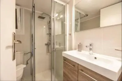 a bathroom with a sink and a shower with a glass door at Acropolis Vista Retreat in Athens