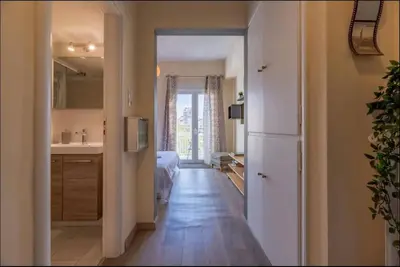 a room with a hallway with a kitchen and a bedroom at Acropolis Vista Retreat in Athens
