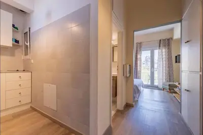a room with a hallway with a large wall at Acropolis Vista Retreat in Athens