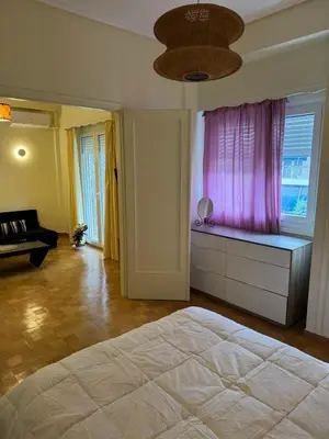 a bedroom with a large bed and a pink window at Cozy place at the center of Athens in Athens