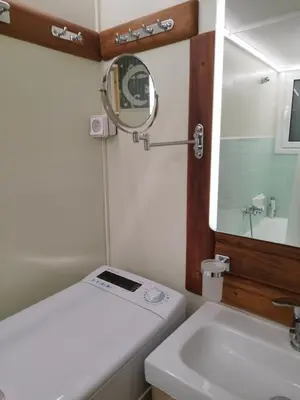 a small bathroom with a sink and a mirror at Cozy place at the center of Athens in Athens