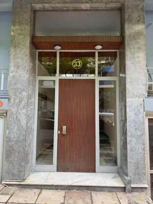 a front door of a building with a sign on it at Cozy place at the center of Athens in Athens