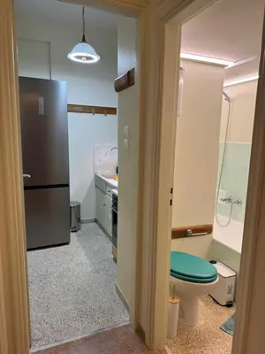 a kitchen with a toilet and a sink and a refrigerator at Cozy place at the center of Athens in Athens