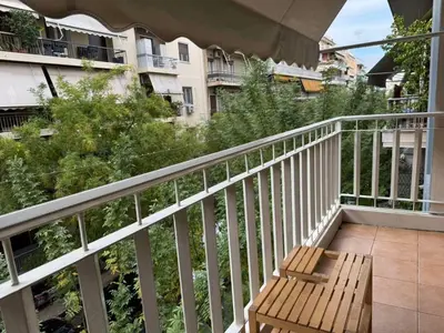 a wooden bench sitting on top of a balcony at Cozy place at the center of Athens in Athens