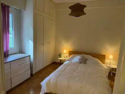 a bedroom with a white bed and a window at Cozy place at the center of Athens in Athens