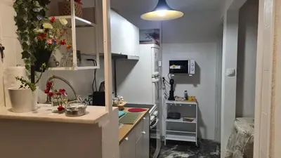 a small kitchen with a counter and a refrigerator at Athens city view loft on a budget in Athens