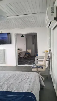 a bedroom with a bed and a chair and a table at Athens city view loft on a budget in Athens