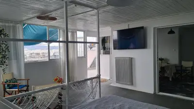 a room with a balcony with a view of a table at Athens city view loft on a budget in Athens