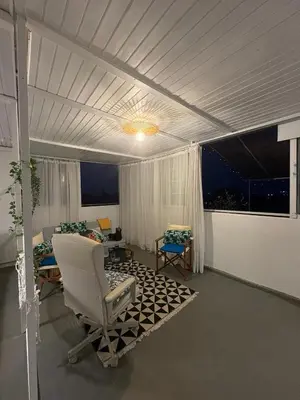 a living room with a couch and a chair at Athens city view loft on a budget in Athens