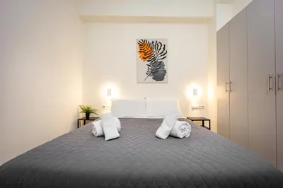 a bedroom with a large bed with two white pillows at DownTown Vibe #3 in Athens