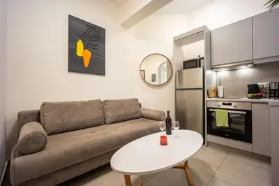 a living room with a couch and a table at DownTown Vibe #3 in Athens