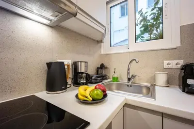 a kitchen with a bowl of fruit on a counter at DownTown Vibe #3 in Athens