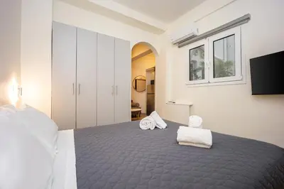 a bedroom with a bed with two towels on it at DownTown Vibe #3 in Athens