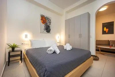 a bedroom with a large bed with towels on it at DownTown Vibe #3 in Athens