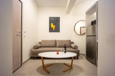 a living room with a couch and a table at DownTown Vibe #3 in Athens