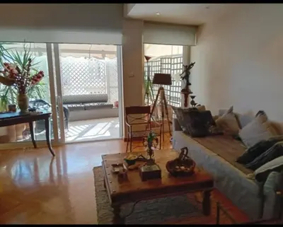 a living room with a couch and a coffee table at Kolonaki Art Suite in Athens