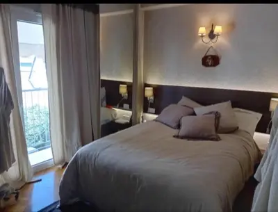 a bedroom with a large white bed and a window at Kolonaki Art Suite in Athens