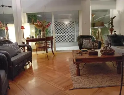a living room with chairs and a coffee table at Kolonaki Art Suite in Athens