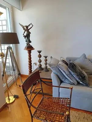 a living room with a chair and a couch at Kolonaki Art Suite in Athens