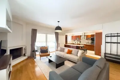 a living room with a couch and a fireplace at Spacious Family Apt in Glyfada in Athens