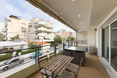 a balcony with a bench and a view of a city at Spacious Family Apt in Glyfada in Athens