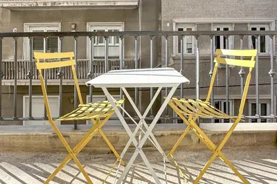 two yellow chairs and a white table and chairs at Phaedrus Living Kolonaki Blue in Athens