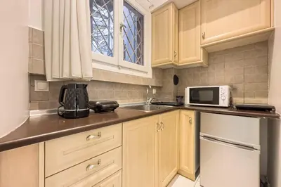 a small kitchen with a sink and a microwave at Phaedrus Living Kolonaki Blue in Athens