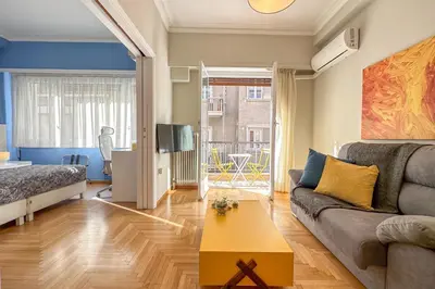 a living room with a couch and a table at Phaedrus Living Kolonaki Blue in Athens