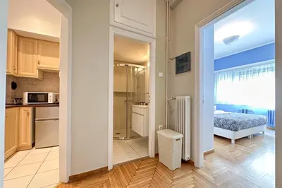a kitchen and a bedroom with a bed and a kitchen at Phaedrus Living Kolonaki Blue in Athens