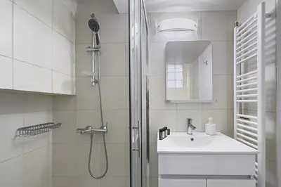 a white bathroom with a shower and a sink at Phaedrus Living Kolonaki Blue in Athens