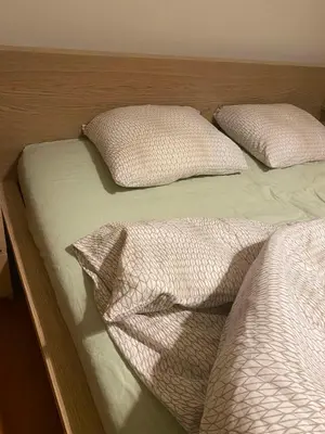 two unmade beds with pillows on top at Spyros apartment 2 in Athens