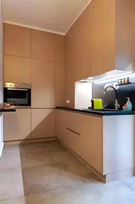 a kitchen with white cabinets and a sink at 2 Bedroom Apt with Secret Garden In The heart Of Athens in Athens