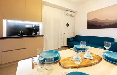 a living room with a table with plates and wine glasses at 2 Bedroom Apt with Secret Garden In The heart Of Athens in Athens