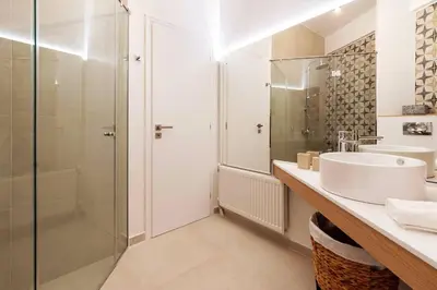 a bathroom with a sink and a shower at 2 Bedroom Apt with Secret Garden In The heart Of Athens in Athens