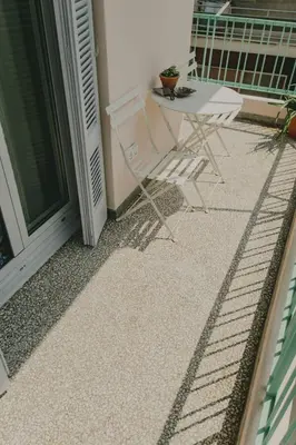 a patio with a table and chairs on a balcony at Stylish cozy artistic Athens apartment in Athens