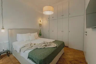 a bedroom with a bed with a blanket on it at Stylish cozy artistic Athens apartment in Athens