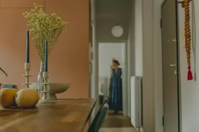 a woman in a blue dress standing in a hallway at Stylish cozy artistic Athens apartment in Athens
