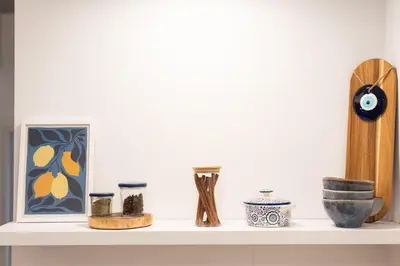 a shelf with vases and other items on it at My Happy Greek Home in Athens