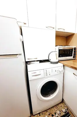 a kitchen with a washing machine and a refrigerator at Apollonas in Athens